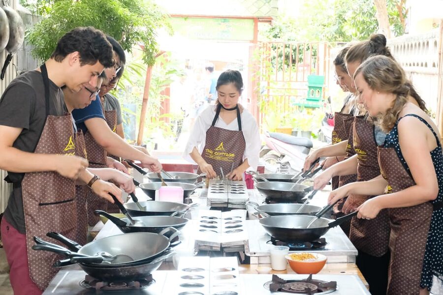 Chiang Mai: Cooking Class, Market & Thai Herbs Garden Tour - Grinding curry paste the traditional way