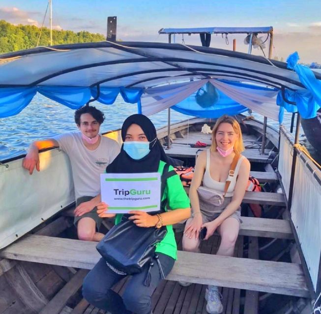 Krabi: Private Sunset Boat Trip and Night Market Tour - Boarding the long-tail boat at dusk