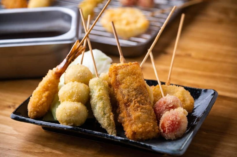 Osaka: Food Tour Kuromon Market & Dotonbori with Guide - A custard tart before the neon streets