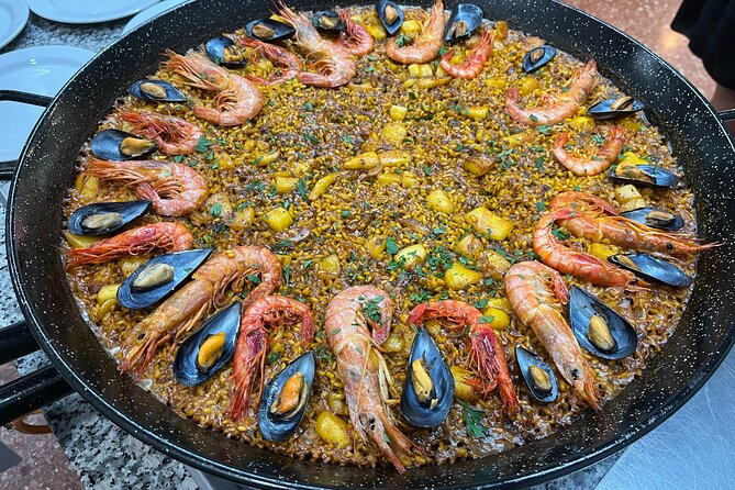 Seafood paella cooking class, tapas and visit to Ruzafa market. - Sitting down to eat what you cooked