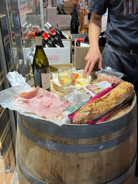 Versailles: Local & small-group Farmers' Market Food Tour - Choosing wine, then walking through Saint-Louis